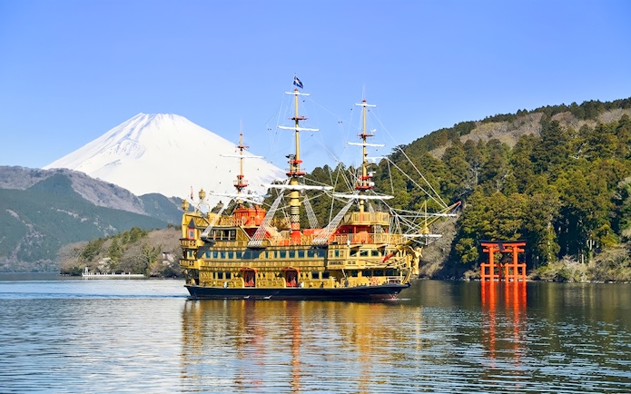 Pirate ship on Lake Ashi with Mount Fuji and torii gate, Hakone, Japan.