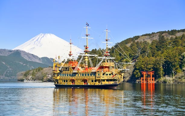 Pirate ship on Lake Ashi with Mount Fuji and torii gate, Hakone, Japan.