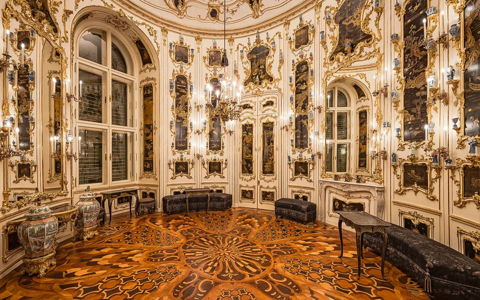 Ornate room interior at Schönbrunn Palace, Vienna, featuring intricate wood flooring and decorative walls.