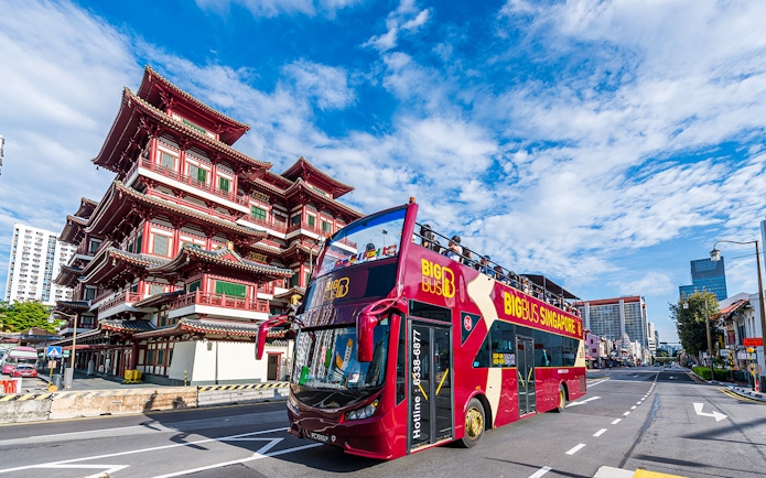 Open-top tour bus near Buddha Tooth Relic Temple, Singapore.