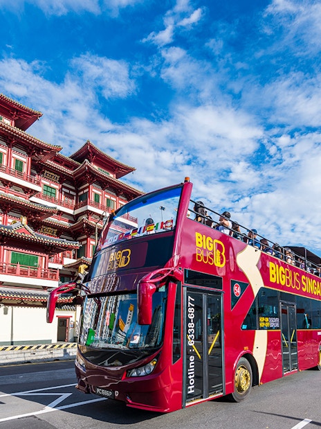 Open-top tour bus near Buddha Tooth Relic Temple, Singapore.
