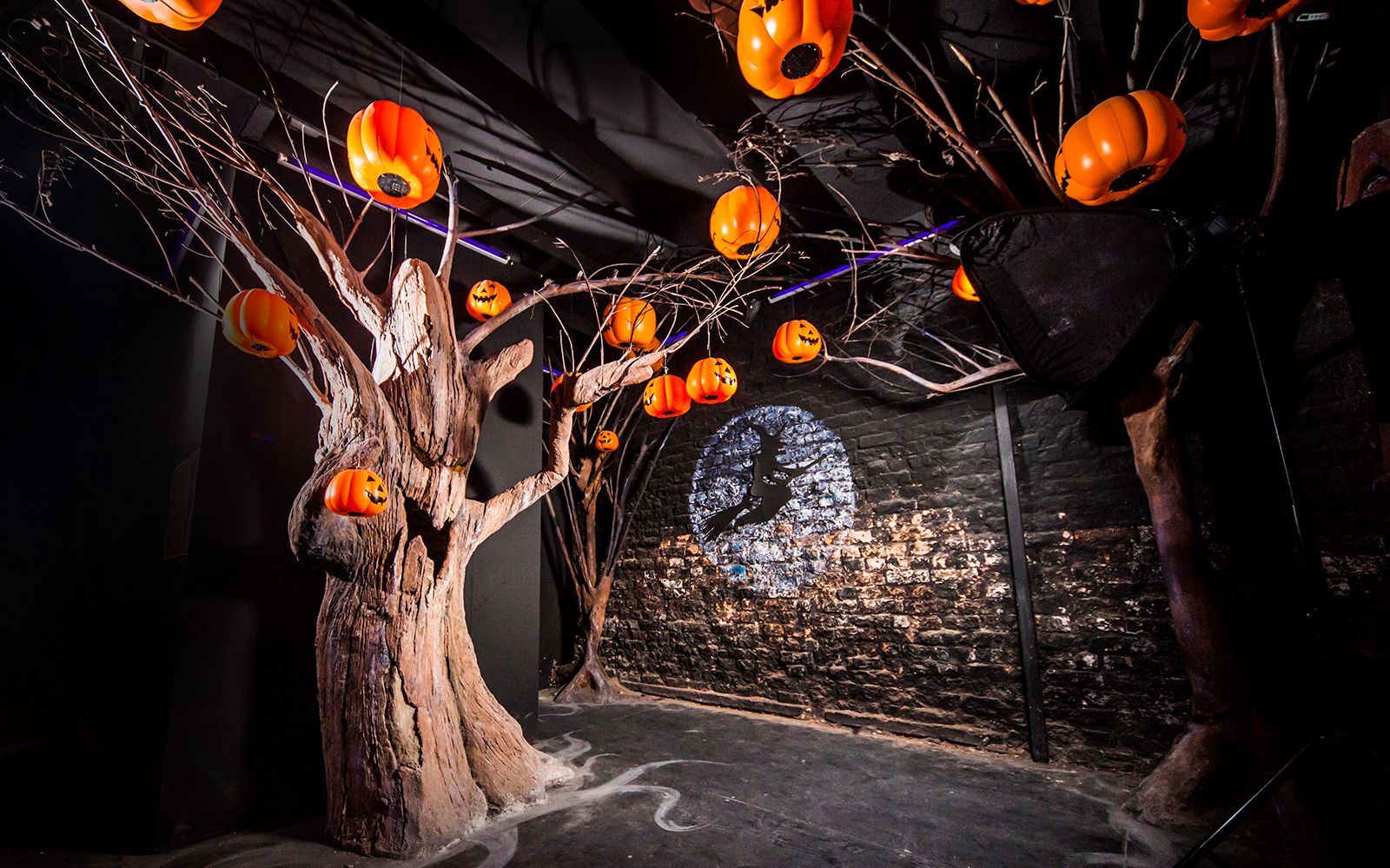 Halloween-themed room with jack-o'-lanterns and witch silhouette at Ghost Museum Penang.