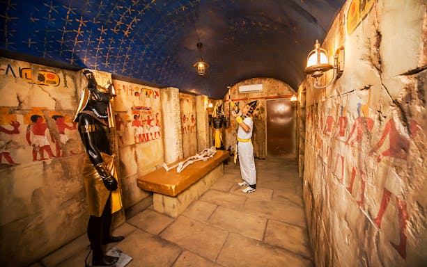 Ancient Egyptian-themed room with hieroglyphics and statues at Ghost Museum Penang.