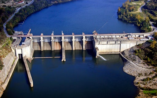 Dam on the Douro River during a scenic cruise from Porto to Règua, surrounded by lush landscape.