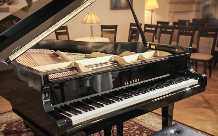Grand piano in a concert hall setting for an Evening Chopin Piano Concert.