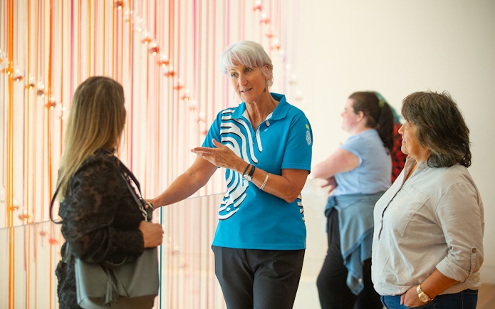 Guide explaining exhibit at Museum of New Zealand Te Papa Tongarewa.