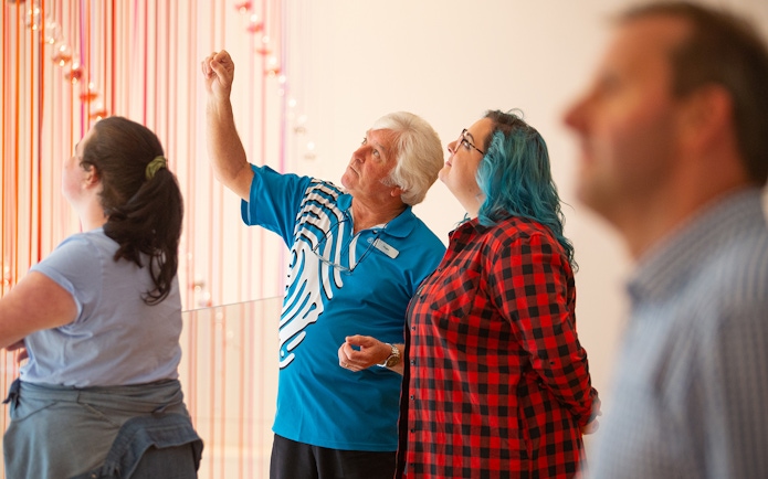 Visitors observing an exhibit at the Museum of New Zealand Te Papa Tongarewa.