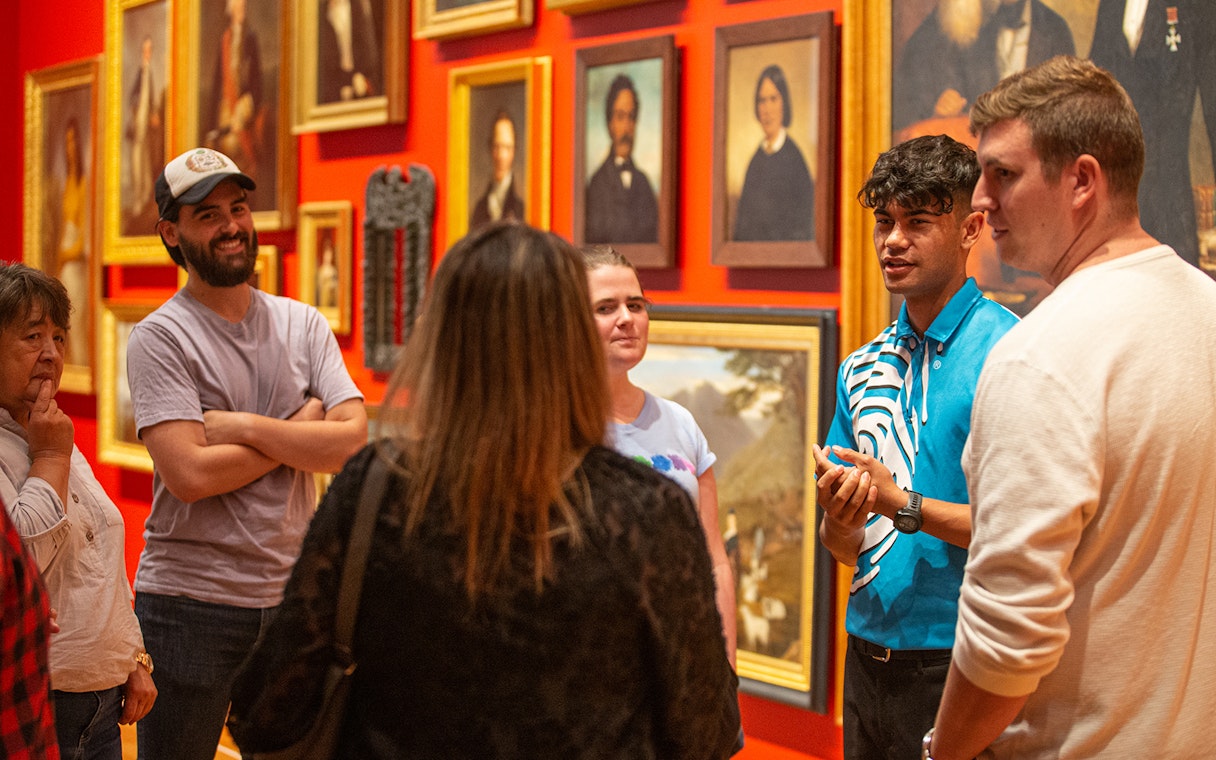 Group tour at Museum of New Zealand Te Papa Tongarewa discussing art exhibits.