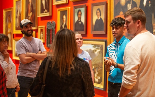 Group tour at Museum of New Zealand Te Papa Tongarewa discussing art exhibits.