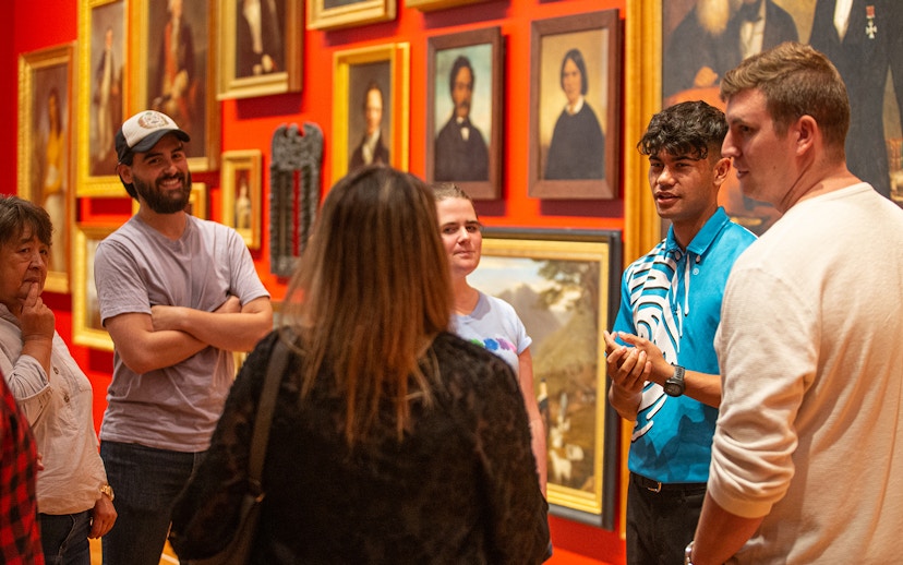 Group tour at Museum of New Zealand Te Papa Tongarewa discussing art exhibits.