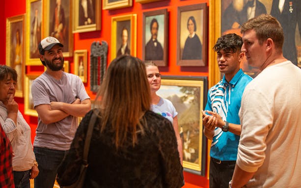 Group tour at Museum of New Zealand Te Papa Tongarewa discussing art exhibits.