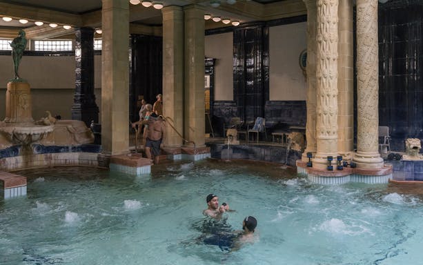 Gellert Bath indoor pool with people enjoying thermal waters in Budapest.