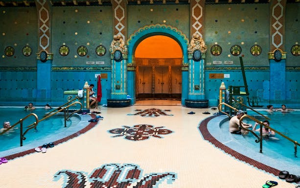 Gellert Bath interior with people enjoying the thermal pool, Budapest.