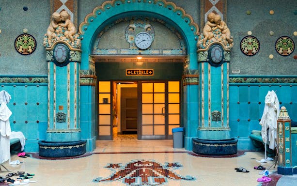 Gellert Bath interior with ornate turquoise tiles and sculptures, Budapest.