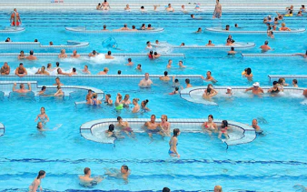 Visitors enjoying the pools at Palatinus Spa, Budapest.