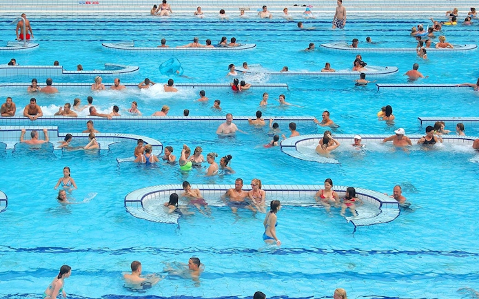 Visitors enjoying the pools at Palatinus Spa, Budapest.