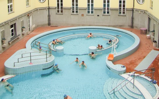 Visitors relaxing in the circular pool at Lukacs Thermal Spa, Budapest.