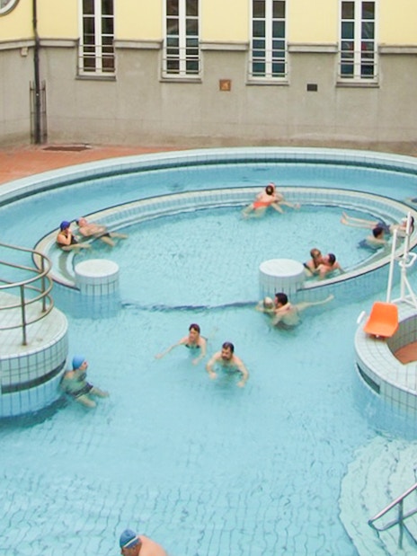 Visitors relaxing in the circular pool at Lukacs Thermal Spa, Budapest.