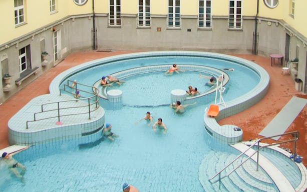 Visitors relaxing in the circular pool at Lukacs Thermal Spa, Budapest.
