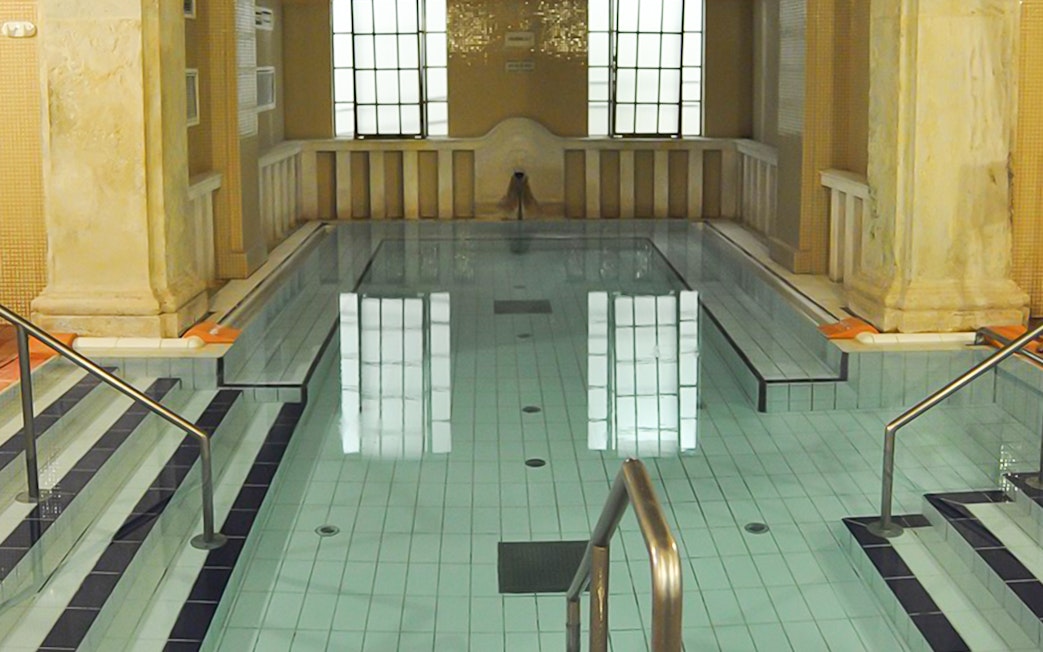 Lukacs Baths indoor pool with steps and handrails in Budapest.