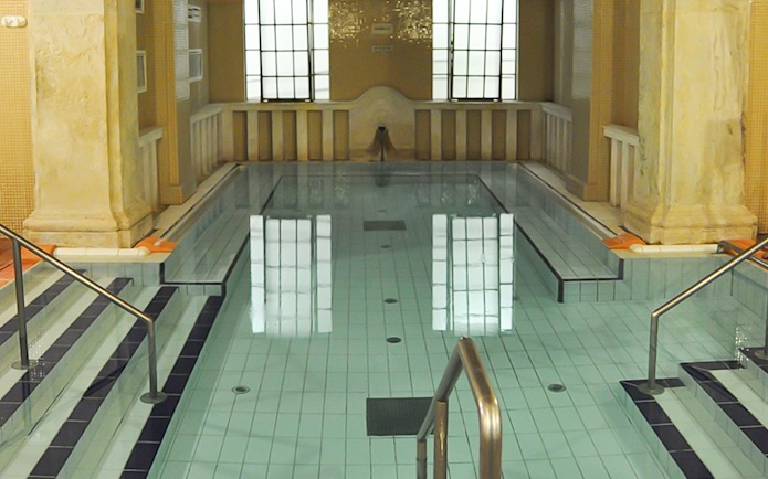 Lukacs Baths indoor pool with steps and handrails in Budapest.