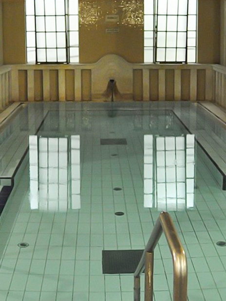 Lukacs Baths indoor pool with steps and handrails in Budapest.