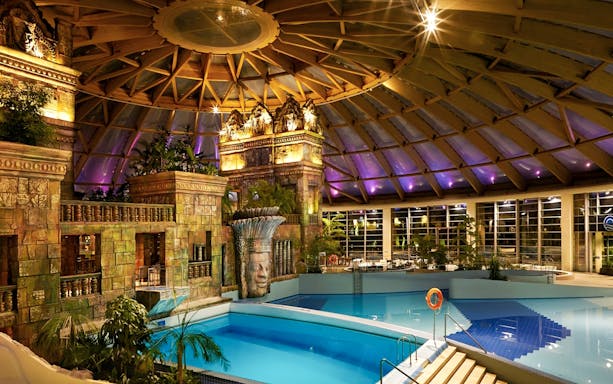 Indoor pool area with themed architecture at Aquaworld Water Park, Budapest.