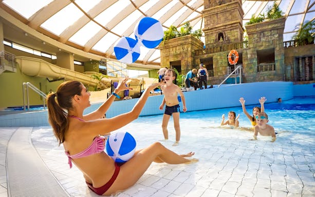 Children playing with beach balls in the pool at Aquaworld Water Park, Budapest.