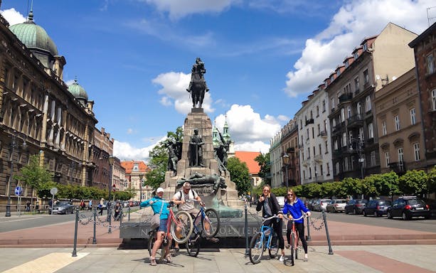 Cyclists at Grunwald Monument, Krakow, during a 4-hour guided bike city tour.