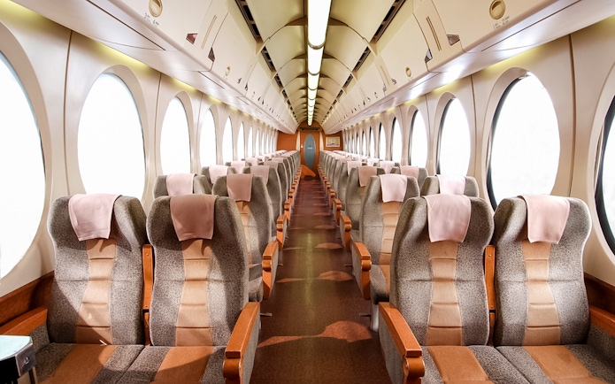 Interior of Nankai Rapi:t train with rows of seats, KIX to Osaka route.