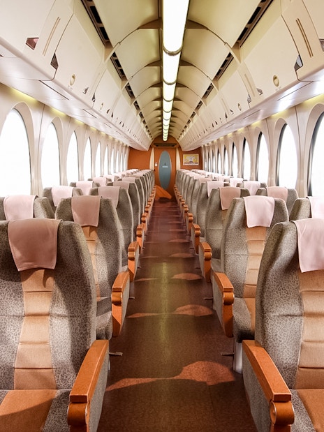 Interior of Nankai Rapi:t train with rows of seats, KIX to Osaka route.
