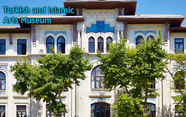 Turkish and Islamic Arts Museum facade in Istanbul with trees in front.