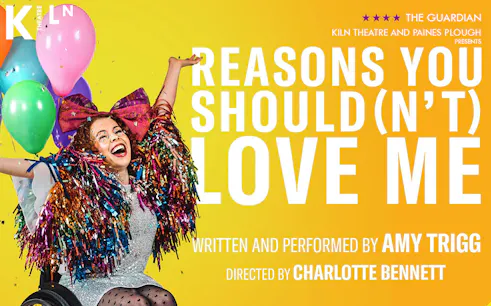 Performer in colorful costume with balloons, promoting "Reasons You Should(n’t) Love Me" at Kiln Theatre.
