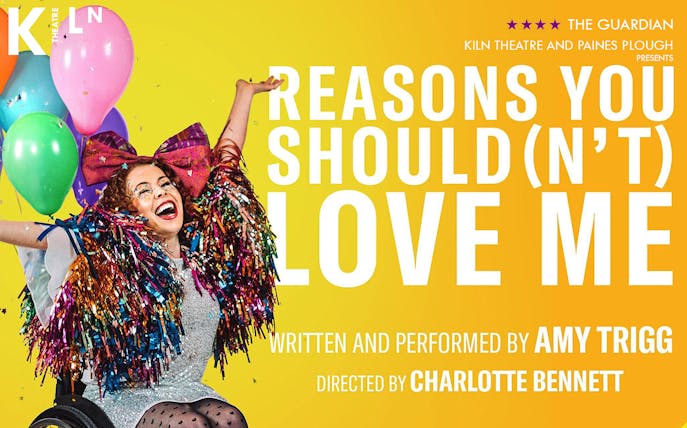 Performer in colorful costume with balloons, promoting "Reasons You Should(n’t) Love Me" at Kiln Theatre.