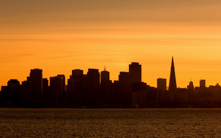San Francisco city bus tour with view of Alcatraz Island in the background.