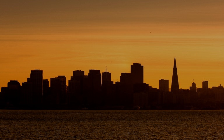 San Francisco city bus tour with view of Alcatraz Island in the background.