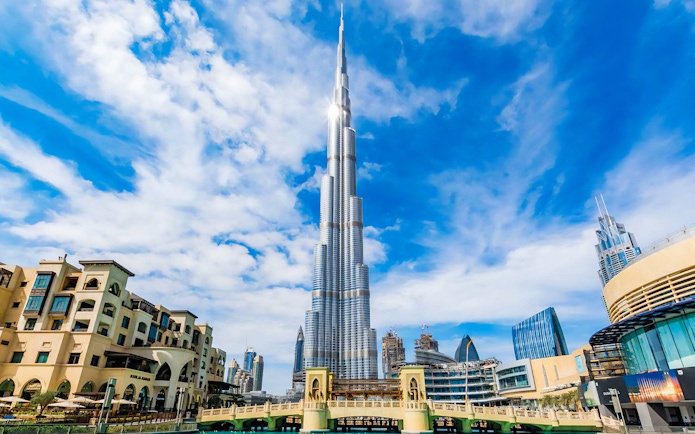Burj Khalifa towering over Dubai skyline on a clear day.