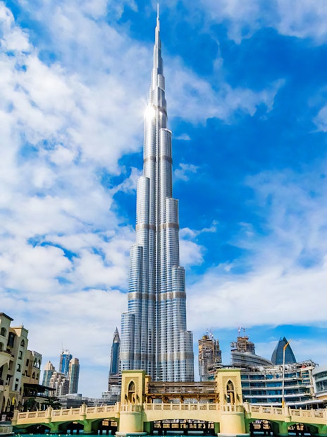Burj Khalifa towering over Dubai skyline on a clear day.