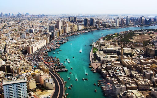 Dubai Creek with boats and city skyline, part of Snapshot Tour of Dubai.