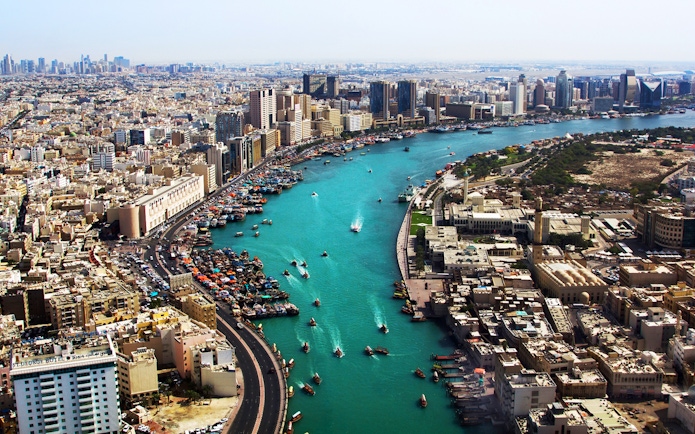 Dubai Creek with boats and city skyline, part of Snapshot Tour of Dubai.