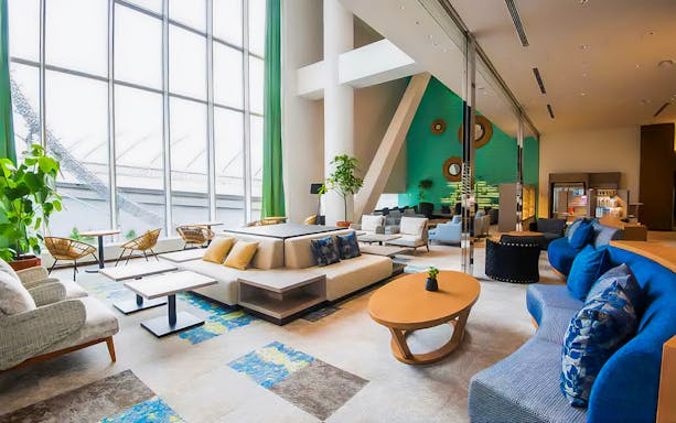 Spa LaQua lounge area with modern seating and large windows in Tokyo.