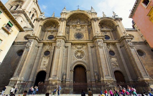 Royal Chapel of Granada facade with visitors outside.
