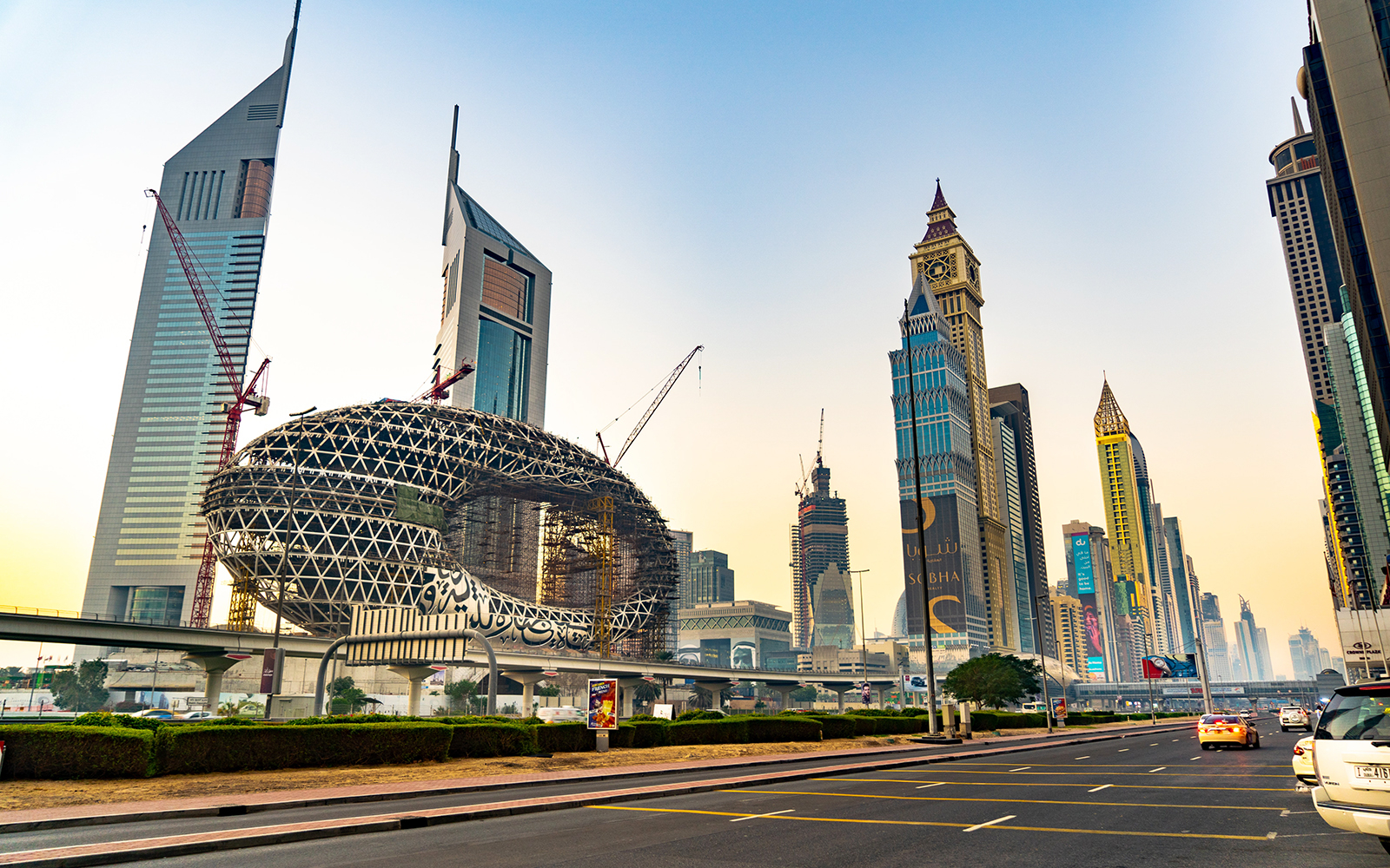 Dubai skyline with modern architecture and monorail track, featuring the Museum of the Future.