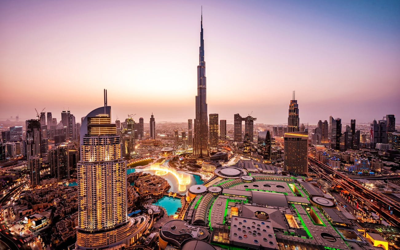 Dubai skyline with Burj Khalifa at sunset, part of the Guided Tour of Dubai Modern City & Monorail Ride Experience.