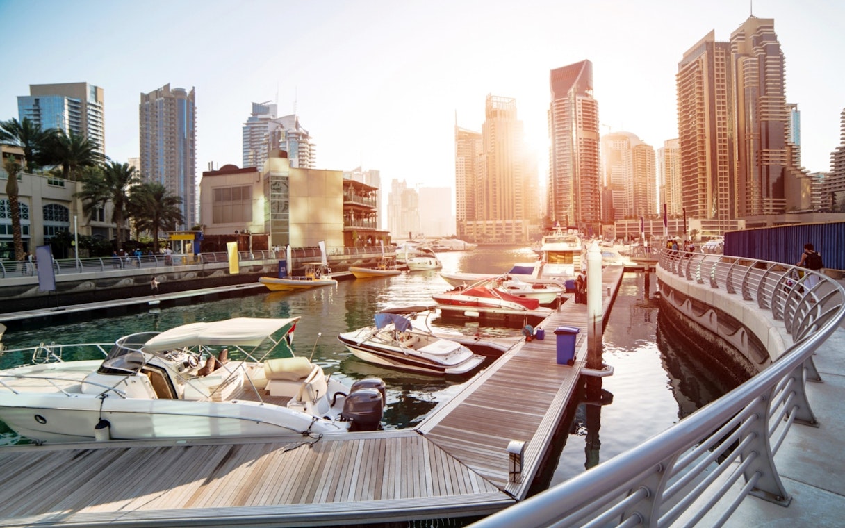 Dubai Marina with yachts and skyscrapers during a guided tour of the modern city and monorail ride experience.