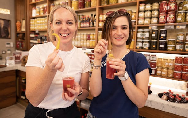 Two people enjoying pickled snacks and drinks on a Taste of Two Continents Food Tour.