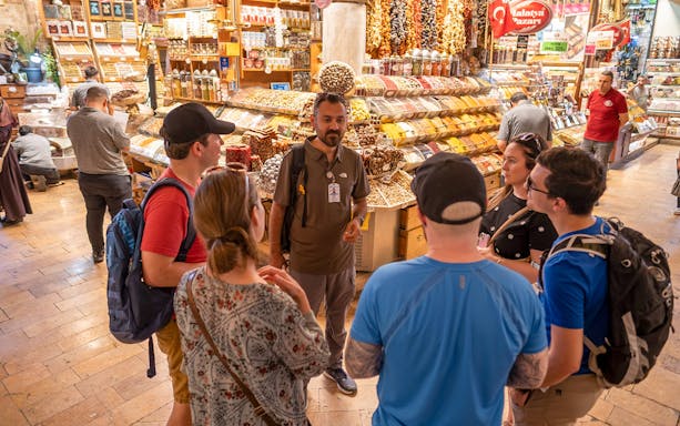Tour group exploring a spice market on the Taste of Two Continents Food Tour.