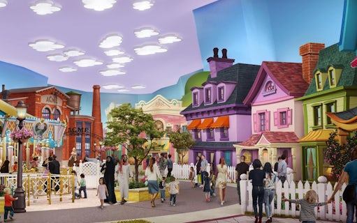 Visitors exploring Warner Bros. themed area with colorful buildings in Abu Dhabi.