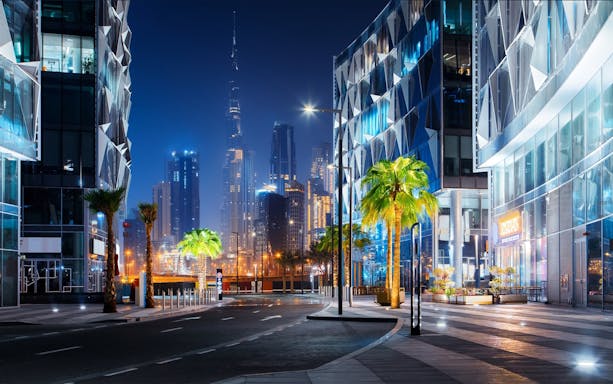 Dubai skyline at night with Burj Khalifa and modern architecture, part of a private night tour.