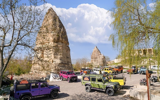 Jeep convoy parked near rock formations in Cappadocia during guided off-road tour.